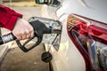 Car fueling at gas station. Refuel fill up with petrol gasoline. Petrol pump filling fuel nozzle in fuel tank of car at gas Royalty Free Stock Photo