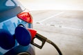 Car fueling at gas station. Refuel fill up with petrol gasoline. Petrol pump filling fuel nozzle in fuel tank of car at gas Royalty Free Stock Photo