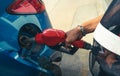 Car fueling at gas station. Refuel fill up with petrol gasoline. Petrol pump filling fuel nozzle in fuel tank of car at gas Royalty Free Stock Photo