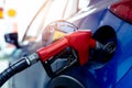 Car fueling at gas station. Refuel fill up with petrol gasoline. Petrol pump filling fuel nozzle in fuel tank of car at gas Royalty Free Stock Photo