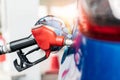 Car fueling at gas station. Refuel fill up with petrol gasoline. Petrol pump filling fuel nozzle in fuel tank of car at gas Royalty Free Stock Photo