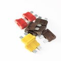 Car fuse. red, yellow, dark. close-up. on a white background Royalty Free Stock Photo