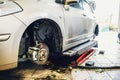 Car in garage of auto repair service shop with special repairing equipment, changing wheels Royalty Free Stock Photo