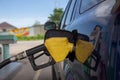 Car gas nozzle auto filling refuel fill up with premium petrol gasoline at gas station, Close up Royalty Free Stock Photo