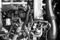 Car gasoline engine. Car engine part. Close-up image of an internal combustion engine. Engine detailing in a new car. Black and wh