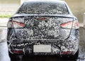 Car getting a wash with soap Royalty Free Stock Photo