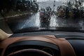 The car goes in the rain. View from the inside. Raindrops on the windshield. Poor visibility and dangerous driving Royalty Free Stock Photo