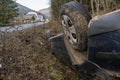 The Car Got Into an Accident on the Mountain Road and fell Upside Down. The Blue Car Turned over in a Ditch near the Royalty Free Stock Photo