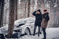 The car got into a skid and crashed into a tree on a snowy road.