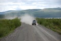 Car at gravel road Kolyma highway at Russian outback