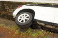 A car in the gutter after a party in the caribbean Royalty Free Stock Photo