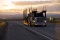 Car hauler semi truck on the road in sunset Royalty Free Stock Photo