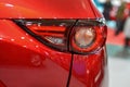 Car headlight with backlight. Exterior detail.Red color car Royalty Free Stock Photo