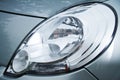 Car headlight close-up. Gray car. Big headlight.