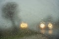 Car headlight lights out of focus on foggy day with rain on the road Royalty Free Stock Photo