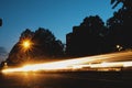 Car headlight streaks of light at night