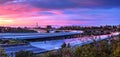 Car headlight trails at sunset traveling across a highway in New Royalty Free Stock Photo