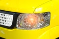Car headlight of yellow automobile closeup Royalty Free Stock Photo