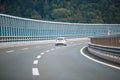 Car on the highway with noise barrier