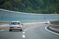Car on the highway with noise barrier