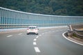 Car on the highway with noise barrier