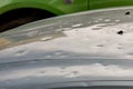 Car hood damaged by major hailstorm hailstones. Car insurance repair dents. Dented car bonnet