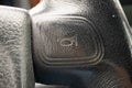 Car horn symbol engraved on steering wheel leather. Close up macro shot, no people Royalty Free Stock Photo