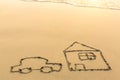 A car and a house drawn by hand on the beach sand in Sunny day. Royalty Free Stock Photo