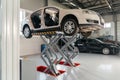 Car on hydraulic lift at auto repair shop. Auto sevice concept