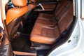 Car inside rear passenger place. Brown interior of prestige modern car. Front seats with steering wheel dashboard. After washing