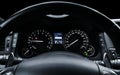 Car instrument panel, dashboard closeup with visible speedometer and fuel level. Modern steering wheel. Modern car interior detail