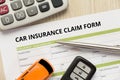 Car insurance claim form with car toy, car key and calculator la Royalty Free Stock Photo