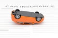 Car insurance concept with accident car toy lay down on desk.