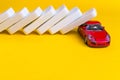 Car insurance concept. Dominoes falling on a red car Royalty Free Stock Photo