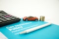 Car insurance concept with car insurance policy and form, calculator, toy car , Pen and coins on a white background Royalty Free Stock Photo