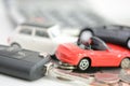 Car insurance concept with toy cars, car key, coins and bills Royalty Free Stock Photo