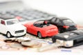 Car insurance concept with toy cars, car key, coins and bills Royalty Free Stock Photo