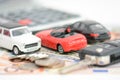 Car insurance concept with toy cars, car key, coins and bills Royalty Free Stock Photo