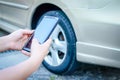 A woman driving an accident uses a smartphone to take a picture of the car. Royalty Free Stock Photo