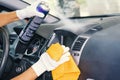 Car interior care services. A plastic cleaner and a rag in the cleaner's hand. Cleaning of the car interior. Cleaning