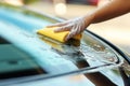 Car interior cleaning service with unrecognizable person, bright wide shot, summer day