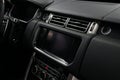 Car interior detail. Panel with multimedia screen, control buttons and air conditioner holes. Royalty Free Stock Photo