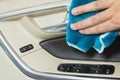 Car interior detailing moving hand of a man is cleaning a door handle of the car