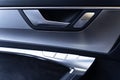 Car interior details of door handle with windows controls. Royalty Free Stock Photo