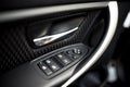Car interior details of door handle, windows controls and adjustments. Car window controls and details