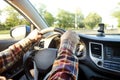 Car interior with male driver sitting behind the wheel, soft sunset light. Luxurious vehicle dashboard and electronics. Royalty Free Stock Photo