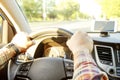 Car interior with male driver sitting behind the wheel, soft sunset light. Luxurious vehicle dashboard and electronics. Royalty Free Stock Photo