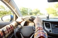 Car interior with male driver sitting behind the wheel, soft sunset light. Luxurious vehicle dashboard and electronics. Royalty Free Stock Photo