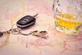 Car key with accident and beer mug on map Royalty Free Stock Photo
