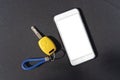 Car key. Auto remote control, flip key on a mobile phone, black background. Vehicle engine start, doors and trunk open and close